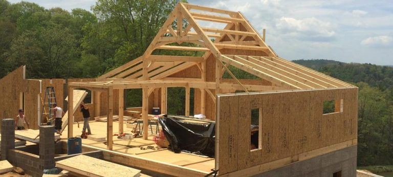 structural insulated wall installation on timberframe