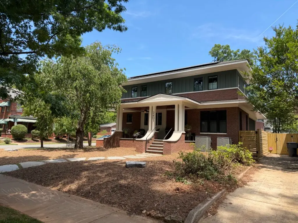 Front exterior of the completed SIP home in Charlotte's Elizabeth neighborhood with a covered porch and brick steps